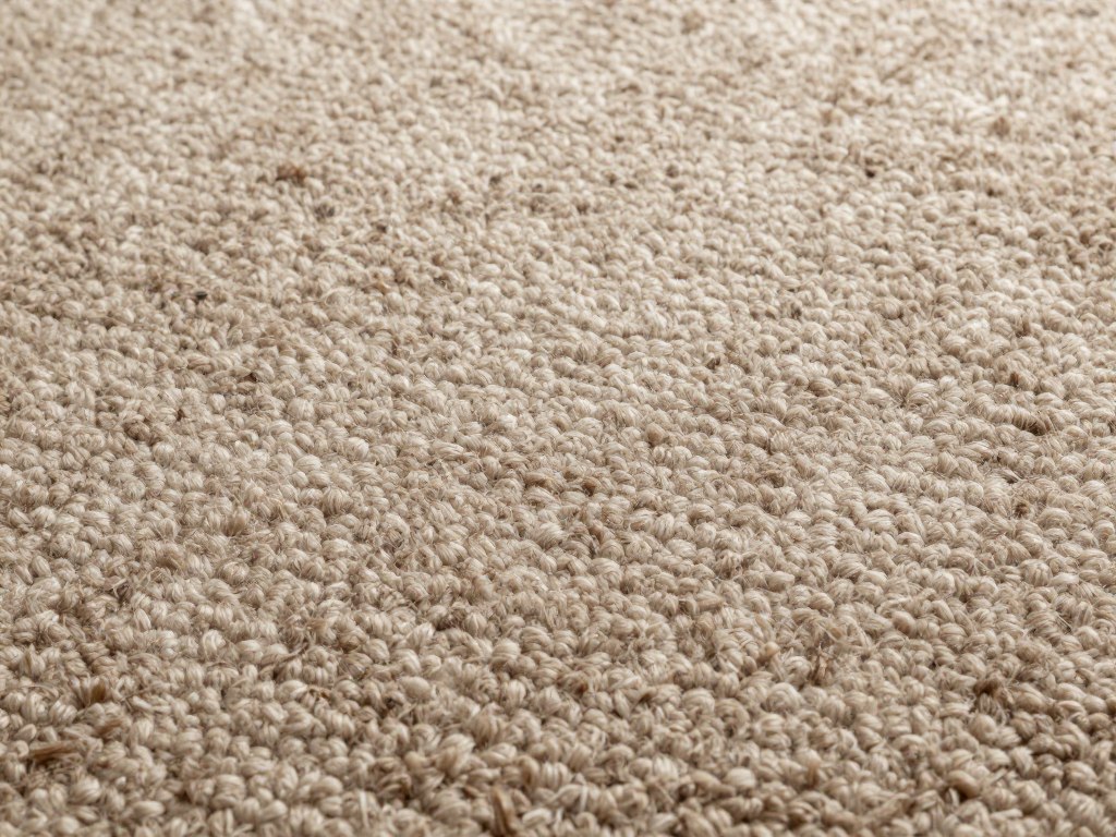 Luxury wool carpet close-up showing natural fiber texture and quality requiring expert care